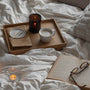 candle, mug, and book on a bed